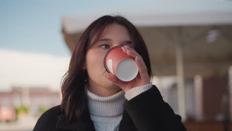 remote worker sipping coffee gently before setting the cup down, enjoying a peaceful moment outdoors, blurred patio and gentle breeze in background