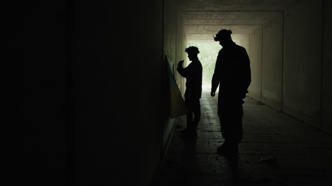 Silhouettes of Soldiers Taking Refuge Inside a Secret Bunker During the War