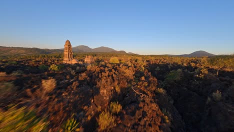 golden sunlight shines over forest around the ruined church of san juan parangaricutiro