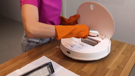 Woman Cleaning a Robot Vacuum