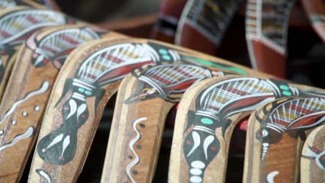 slow pan and closeup of the beautiful artwork of genuinely crafted australian boomerangs