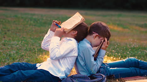 sleeping-student-fixes-pen-in-mouth-leaning-on-schoolmate