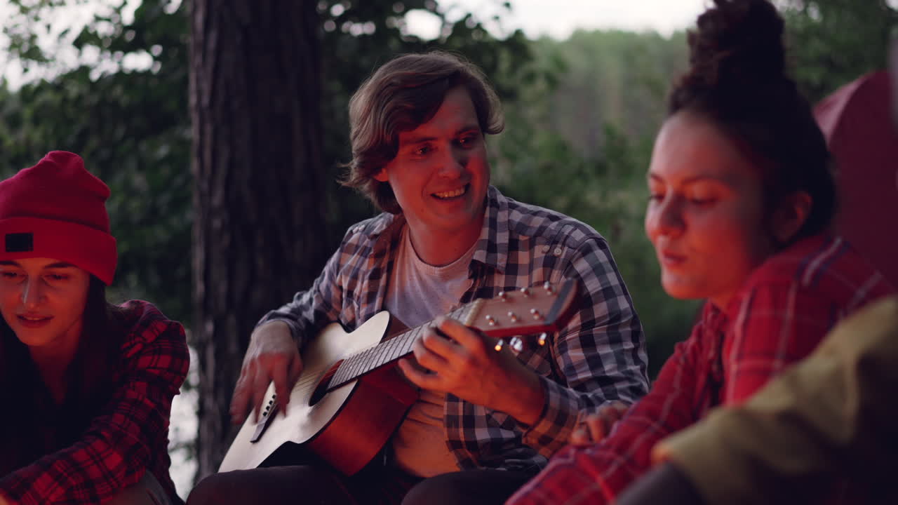 Friends Singing Around a Campfire