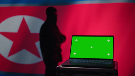 north korea army soldier using military tech on green screen laptop