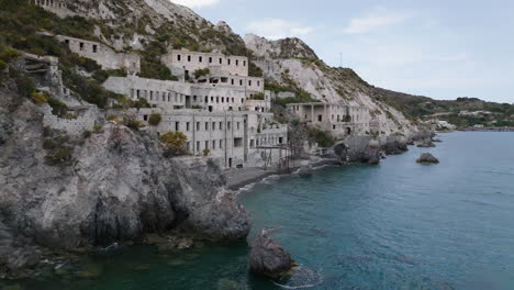 4k aerial lift and reveal lipari abandoned pomice mine accomodation, italy