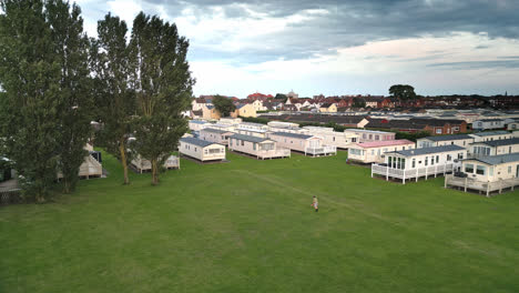 drone captures summer sunset in skegness, showcasing coastal town, holiday park, beach, sea, and caravans in sweeping scenes