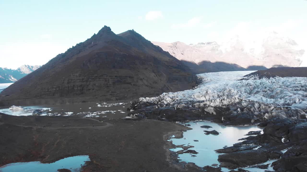Wet muddy ground and ice moraine of Sv&iacute;nafellsj&ouml;kull glacier, Iceland