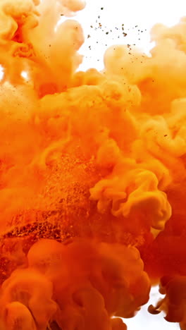 a large orange cloud of smoke is billowing out of a fire. the smoke is thick and billowing, creating a sense of chaos and destruction. the orange color of the smoke contrasts with the white background