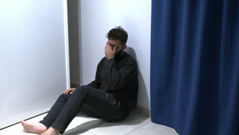 man suffering psychotic episode alone looking at the mirror