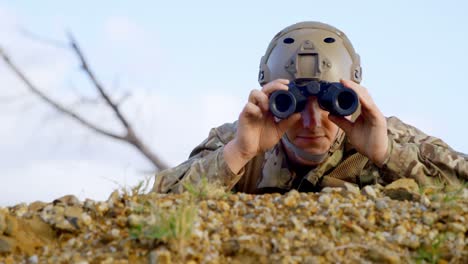 Front-view-of-military-soldier-looking-through-binoculars-during-military-training-4k