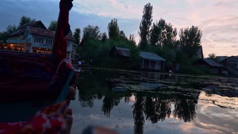view of dal lake from shikara boat sailing at sunset
