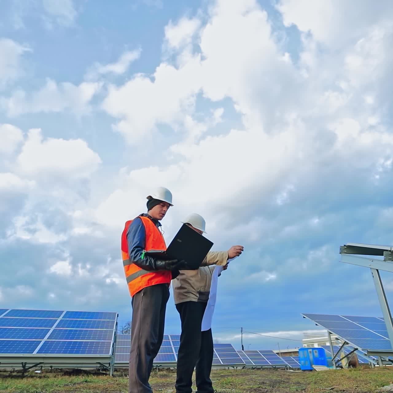 Engineers working at solar panel plant