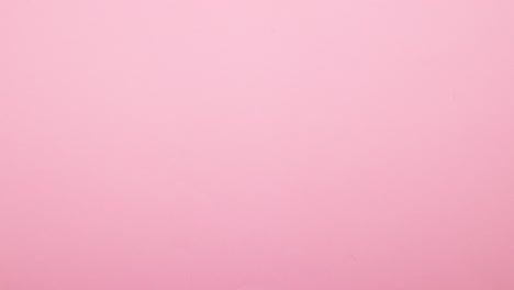 colorful rounds appear and disappear from pink background - stop motion