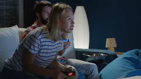 couple playing video games at home