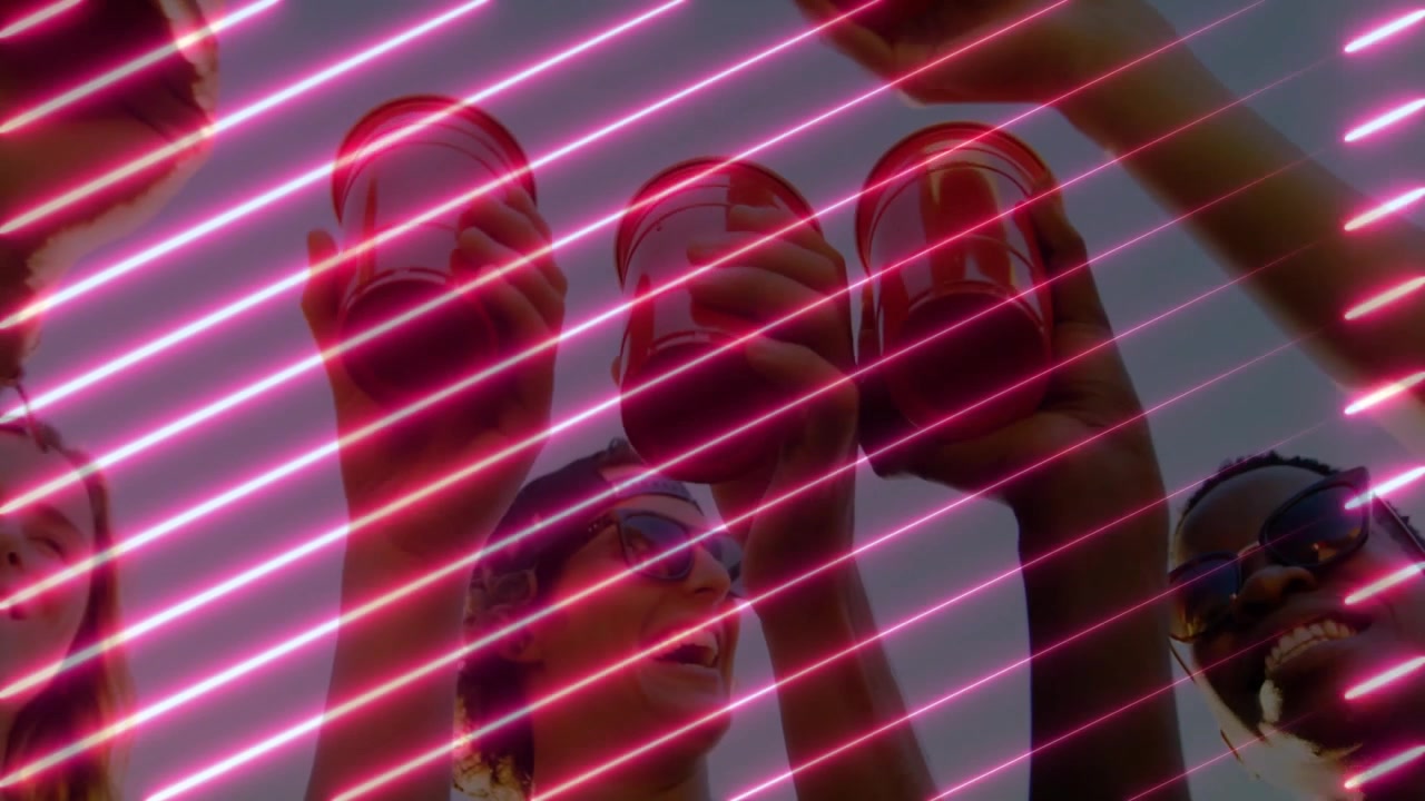 Three friends drinking from red cups on hillside, with neon pink beams showing marketing concept
