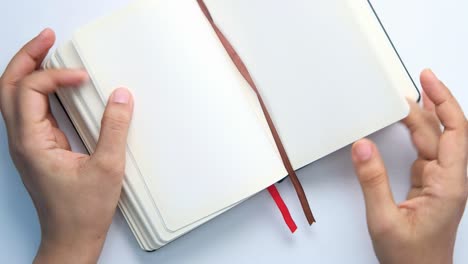 hands holding an open notebook