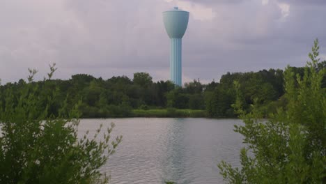 establishing shot of brays bayou in houston’s alief area with light blue water tower