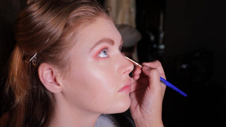 Close-up of model having eye shadow applied by professional make-up artist, smile and laughter - 4K, 23.98fps