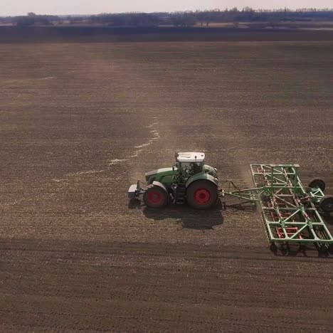 the tractor draws an agricultural device for harrowing the land 5