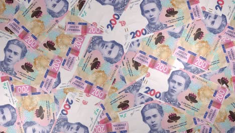 200 ukrainian hryvnia bills background. many banknotes.