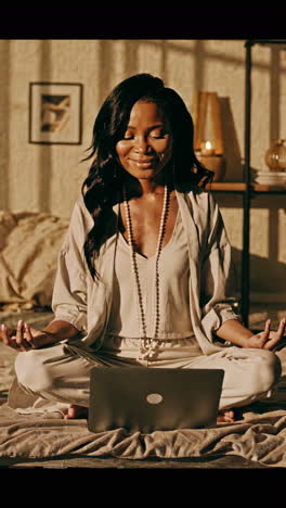 woman meditating with laptop