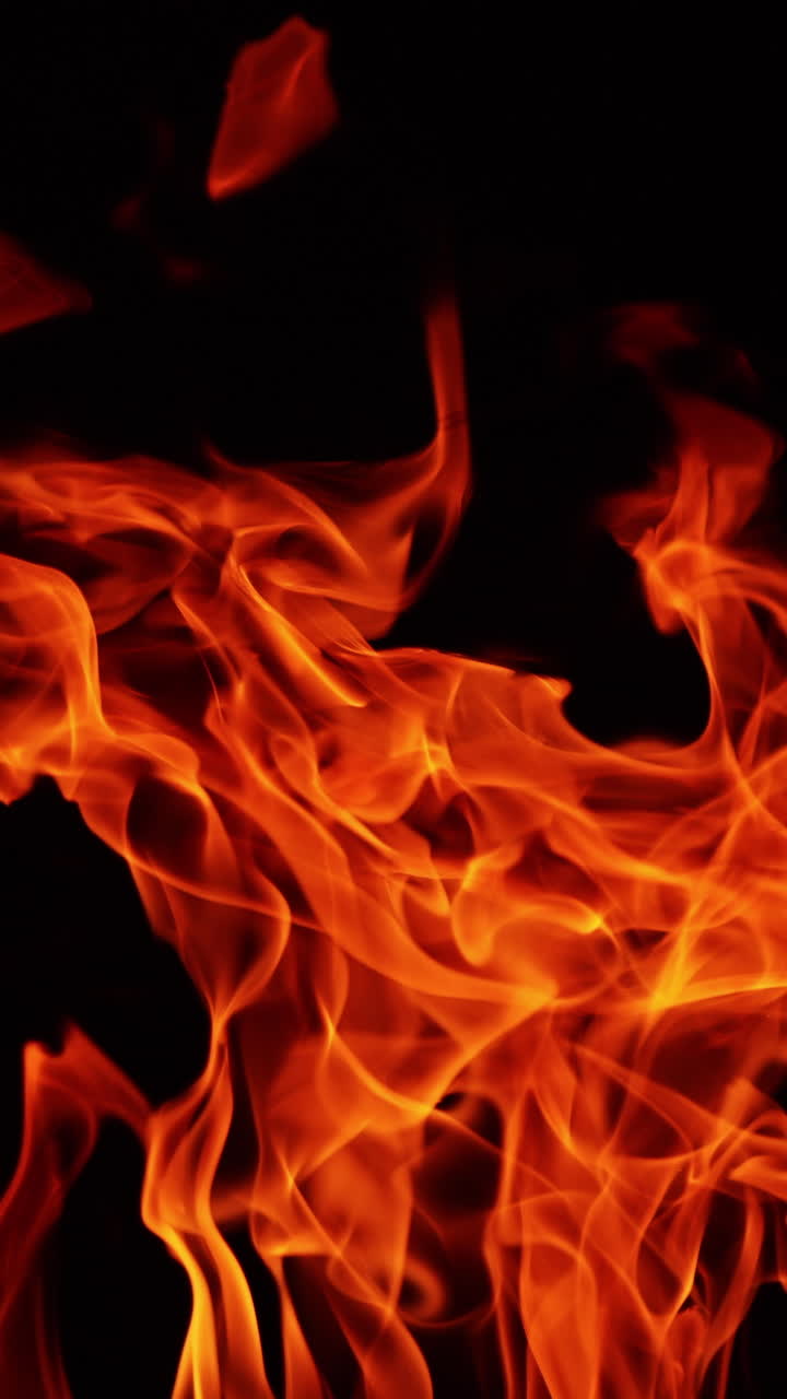 Red blaze upper part view. Campfire burning isolated in the darkness. Close up