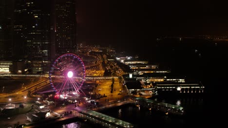 hong kong cityscape at night with ferris wheel