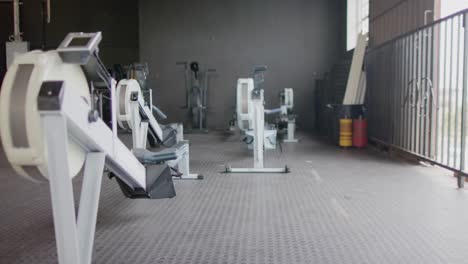 general view of empty fitness room at gym with exercise equipment, in slow motion