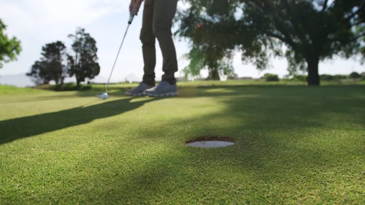 Giocatore di golf che colpisce la palla con la mazza