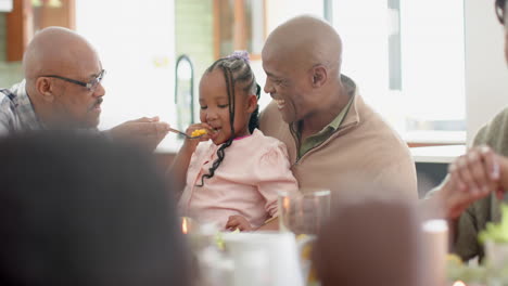 African-american-grandfather,father-and-granddaughter-at-thanksgiving-dinner-,-slow-motion