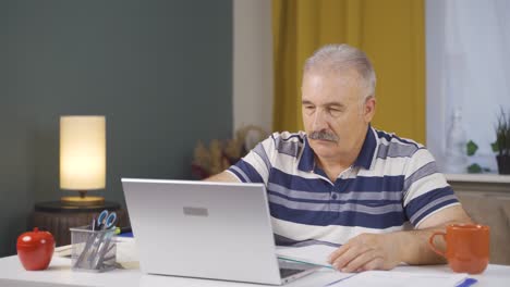 Home office worker old man calculating things.