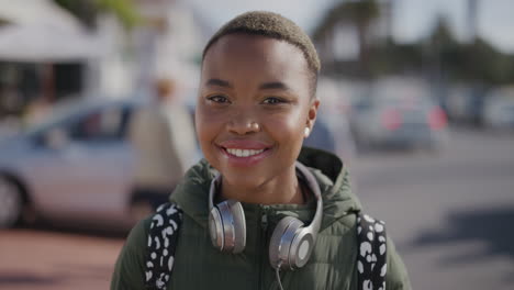 retrato de una joven hermosa mujer afroamericana sonriendo feliz en una vibrante playa urbana disfrutando del verano