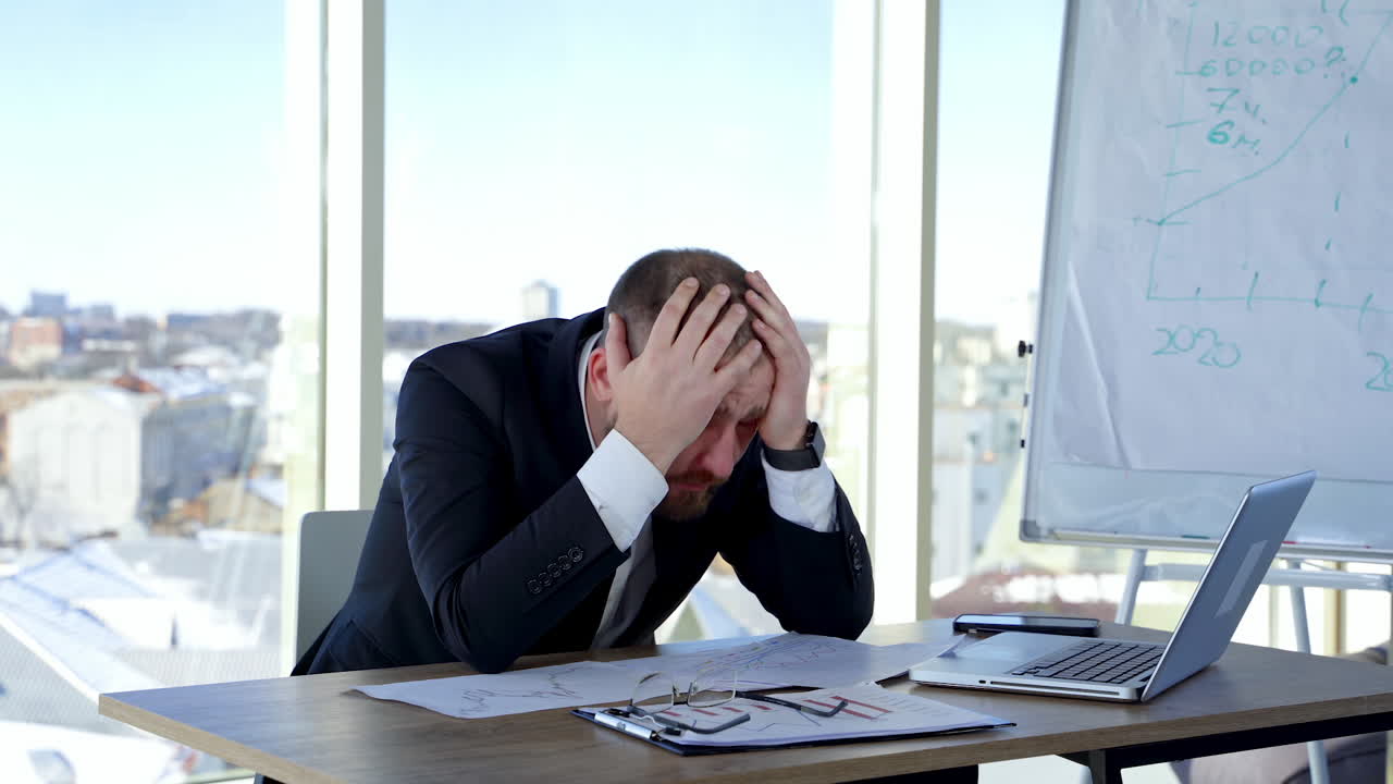 Tired office worker freelancer. Stressful businessman at work in the office