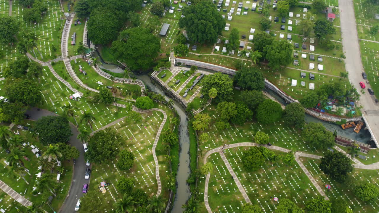 Aerial flyover graves at the Manila memorial park, cloudy day in Philippines