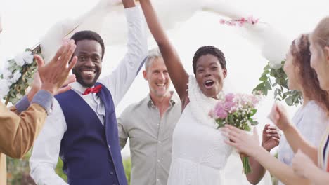 portrait of happy african american couple holding hands during wedding