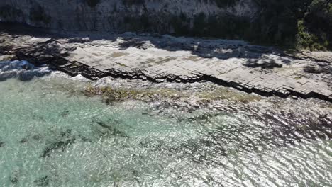 Drone-aerialDrone-aerial-showing-tessellated-pavement-in-Tasmania-over-tropical-blue-beach