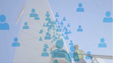 animation of network of profile icons over male architect standing on a windmill