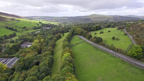 english countryside drone video footage of fields and buildings with dry stone walls