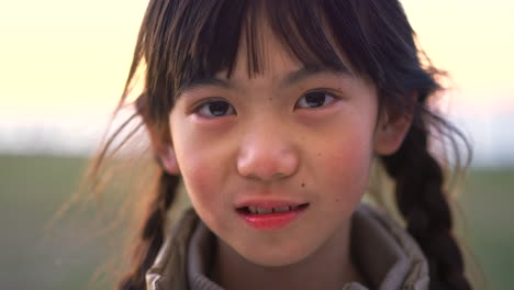 child, face asian girl outside in nature