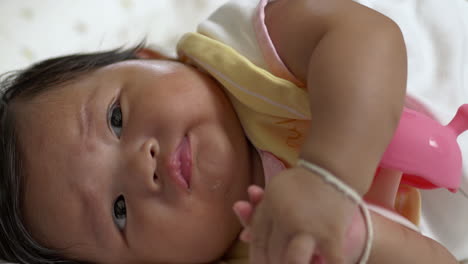 sweet baby girl enjoying finger sucking with thick black hair, representing healthy developmental stages and comfort in infancy