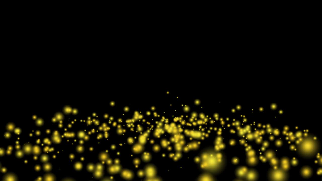빛나는 황금색과 파란색 입자의 큰 그룹이 검은색 배경 4k 비디오에서 무작위로 바닥에 반사합니다.