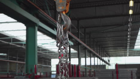 Industrial-construction,-crane-lifting-hook-lifting-steel-chain-heavy-goods