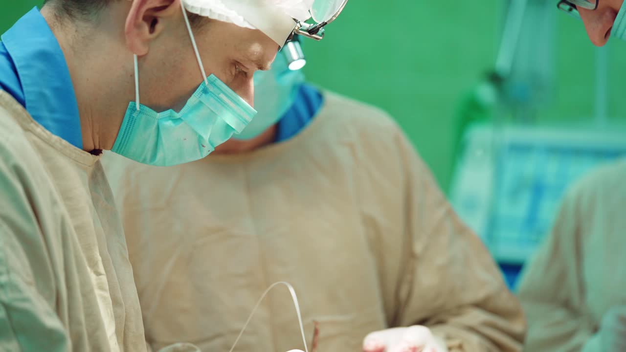 Team of Professional Surgeons. Performing complex operation on a Patient in the Hospital Operating Room. Modern Hospital