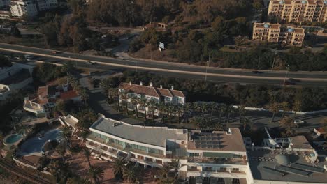 Aerial-view-of-residential-coastline-in-Mijas,-south-of-Spain,-flying-backwards-into-the-sea