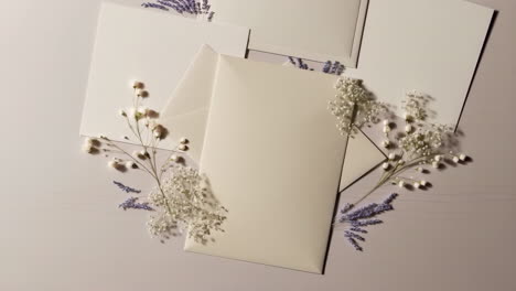 elegant blank envelopes and floral arrangement