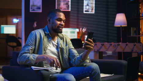vertical video chill self employed guy enjoying a video call on mobile phone at home