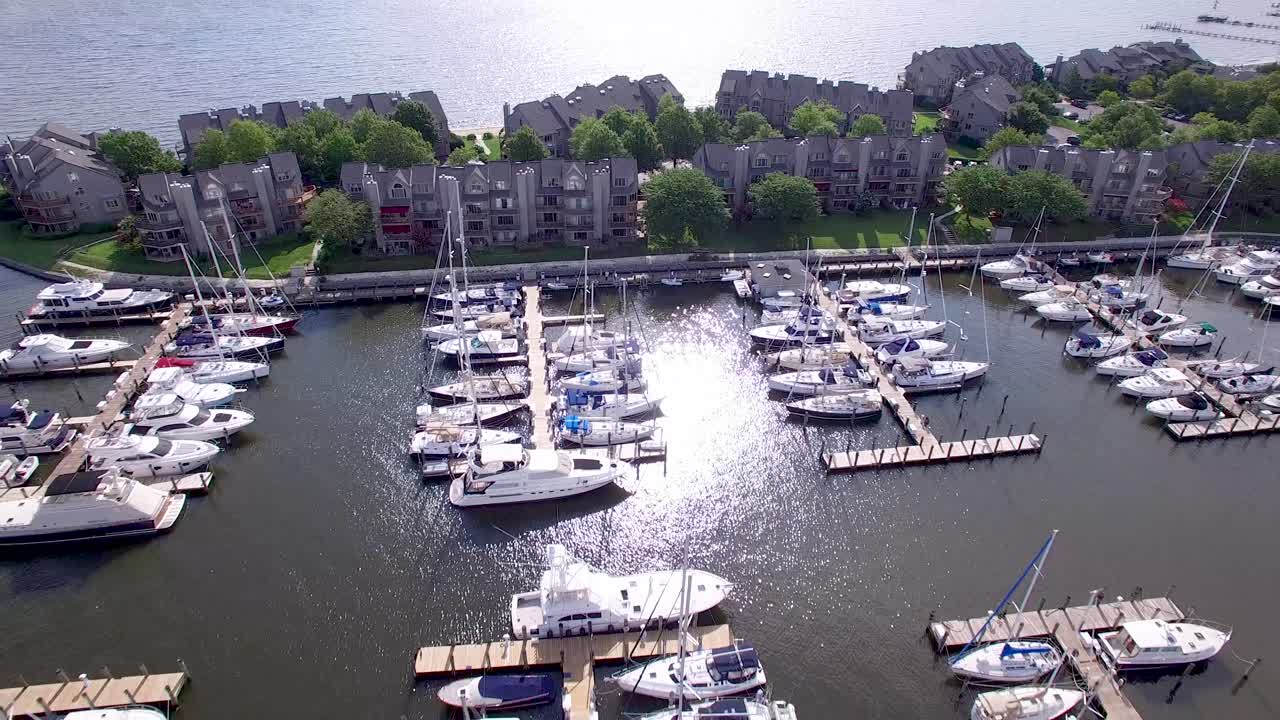 Aerial view of a marina with boats docked near residential buildings