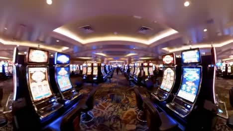 an immersive view inside a vibrant casino filled with rows of slot machines, colorful lights, and a lively atmosphere for gamblers and visitors alike