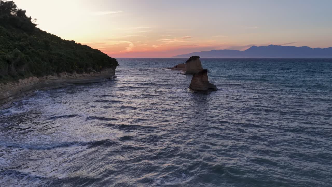 Captivating Corfu Coastal Sunset: Serene seascape with unique rock formations, gentle waves, and a vibrant sky, embodying the tranquil beauty of the Ionian island at dusk.