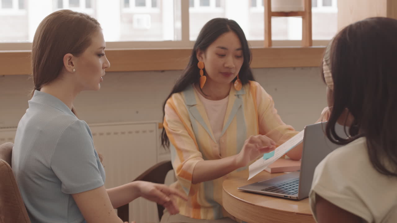 Female Designers Working Together in Cafe